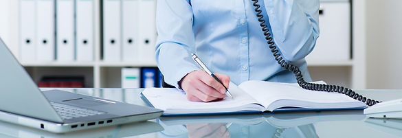 Businessman on the phone with a prospective customer booking a sales appointment.