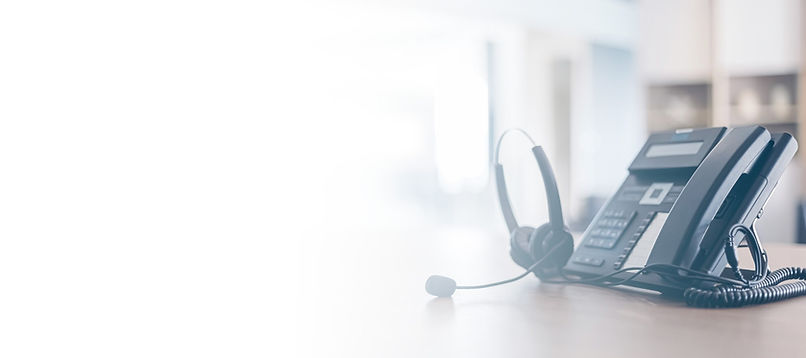 Telemarketing headset and telephone handset in an office.